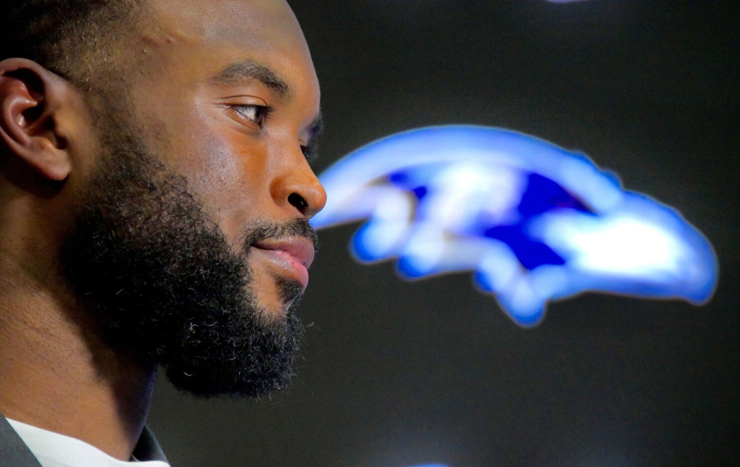 a man with a beard looking away