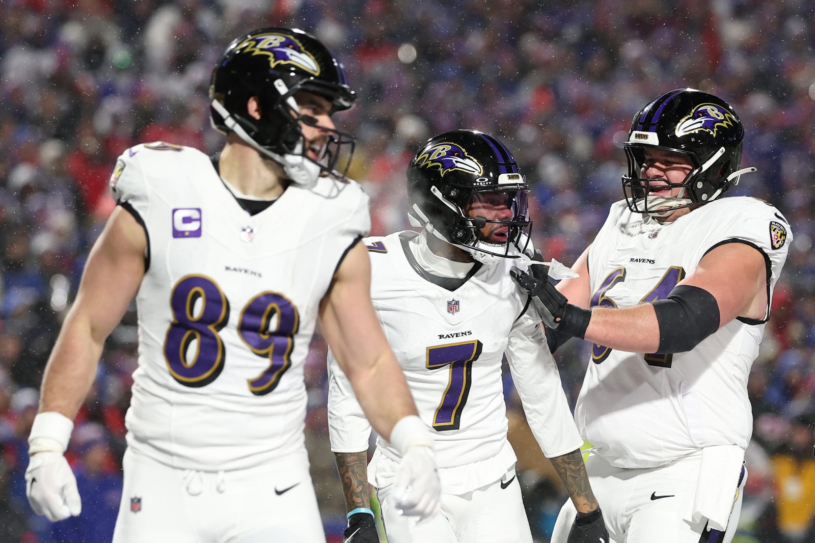 a group of football players in white uniforms