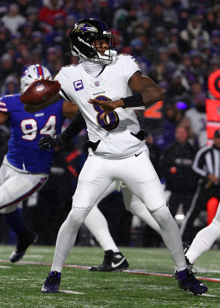 a football player throwing a football