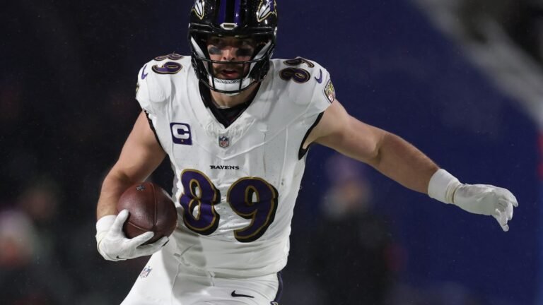 a football player in a uniform holding a football