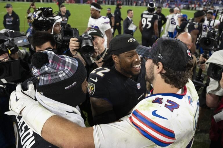 a group of football players with a group of people on a field