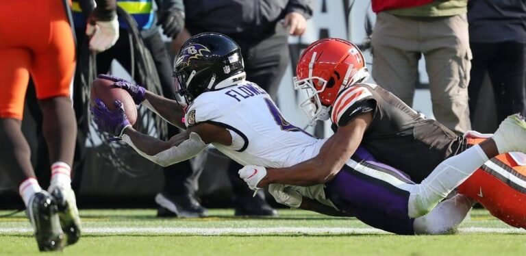 a football player diving for a ball