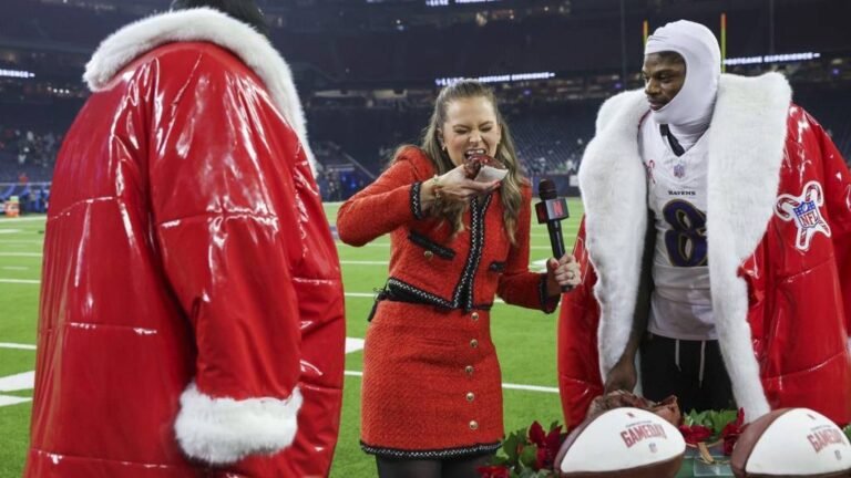 a woman in red dress holding a microphone and a man in a red coat