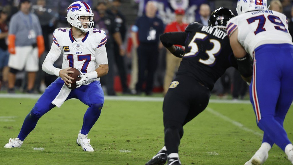 a football player running with a football in his hand