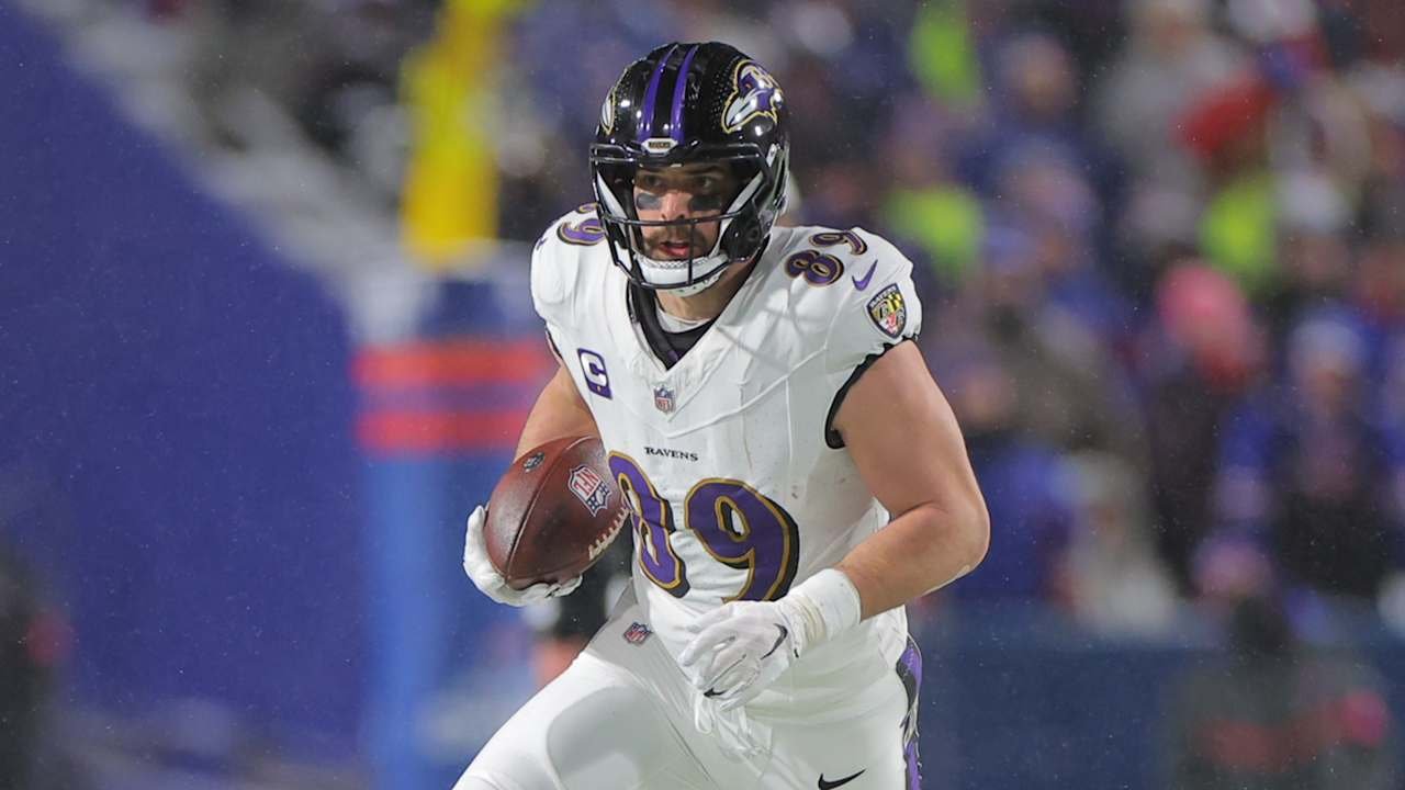 a football player in a uniform holding a football