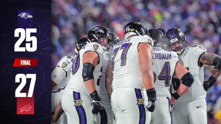a group of football players in a huddle