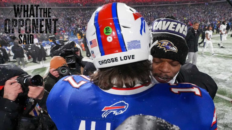 two football players hugging in a stadium