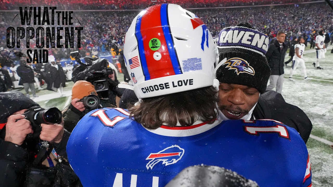 two football players hugging in a stadium
