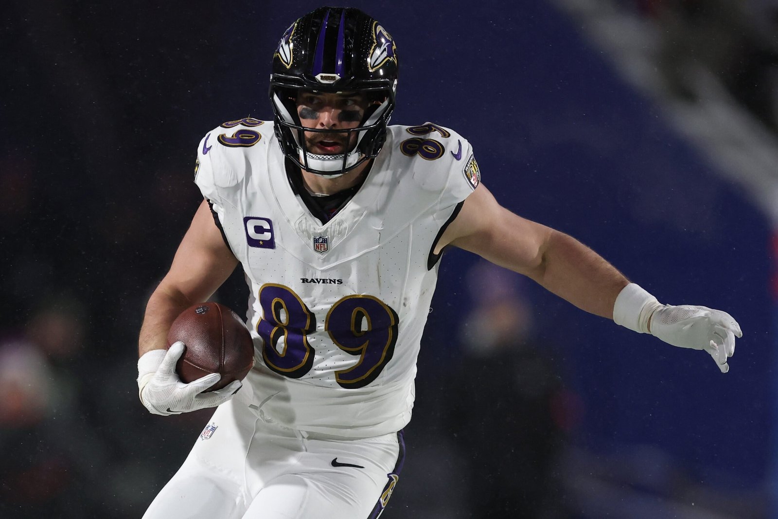 a football player in a uniform holding a football