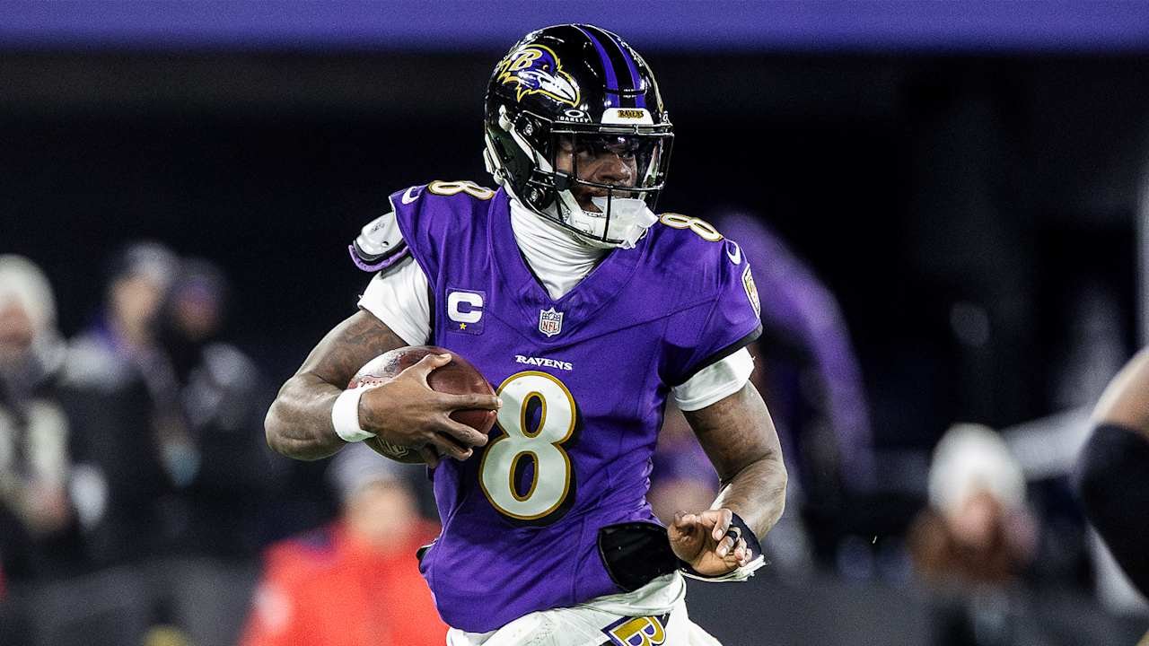 a football player in a purple uniform holding a football