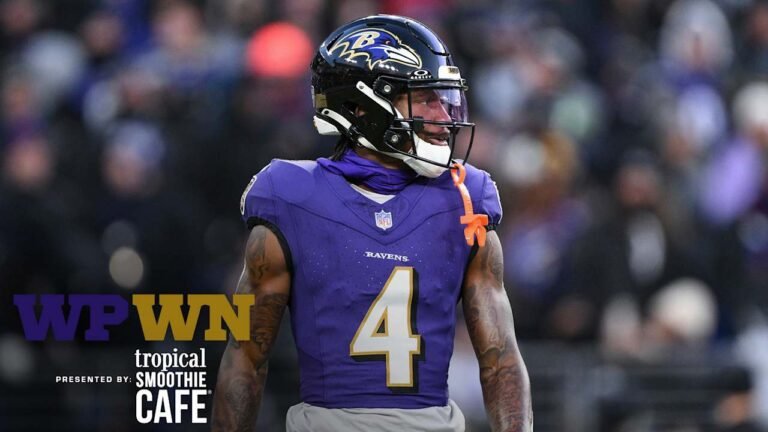 a football player wearing a purple uniform