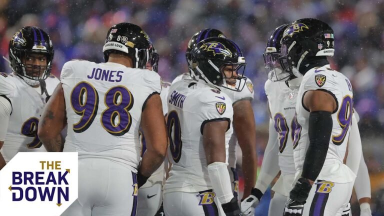 a group of football players in a huddle