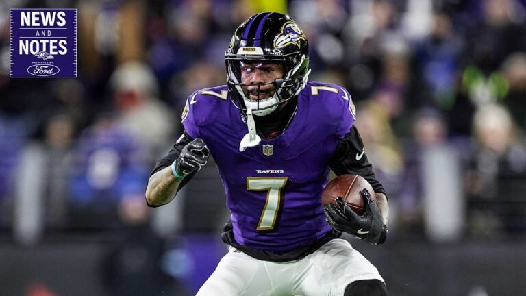 a football player in a purple uniform holding a football