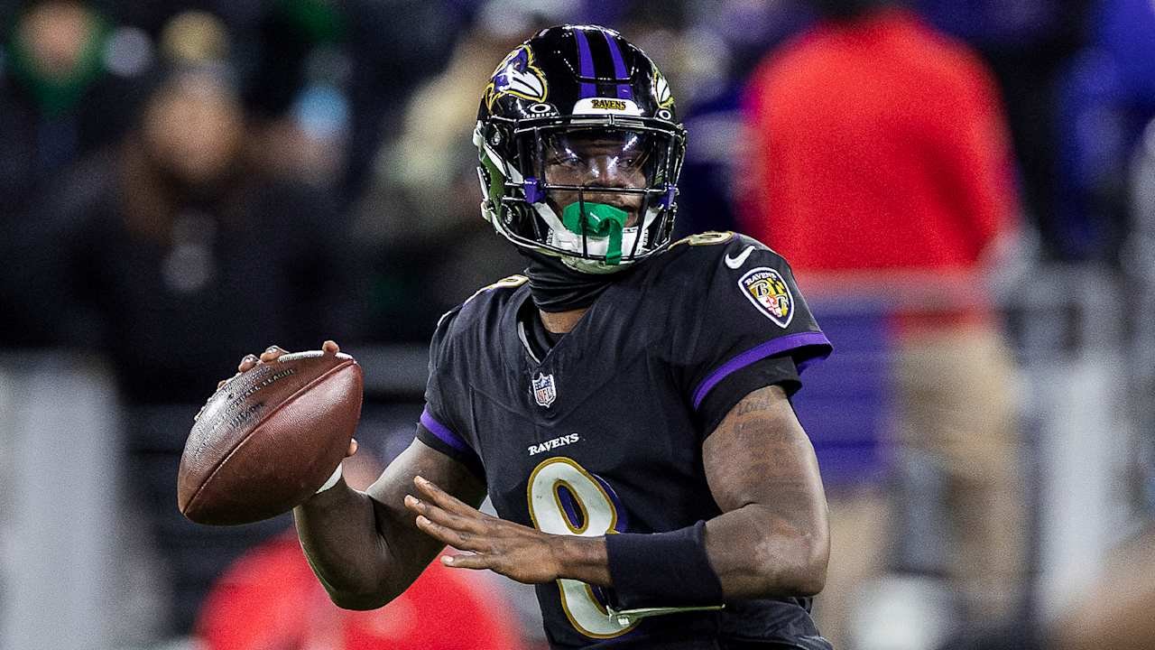 a man in a football uniform holding a football